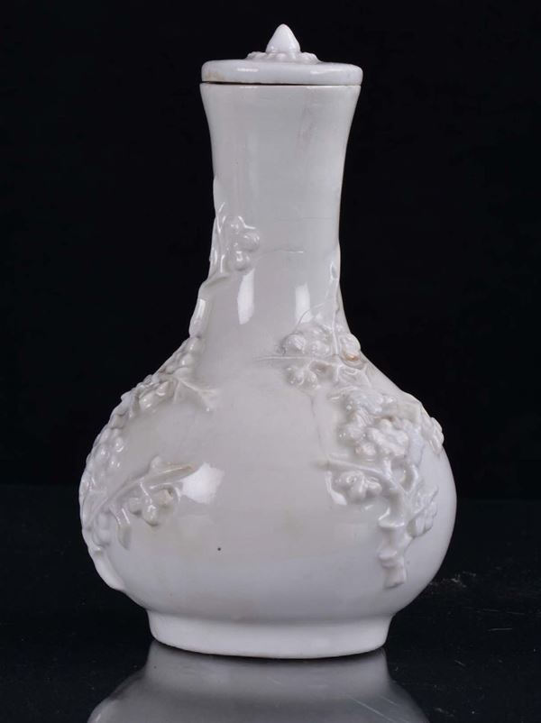 A small Blanc de Chine porcelain capped vase, Dehua, China, Qing Dynasty, end of 17th centuryRelief flowery branch decoration