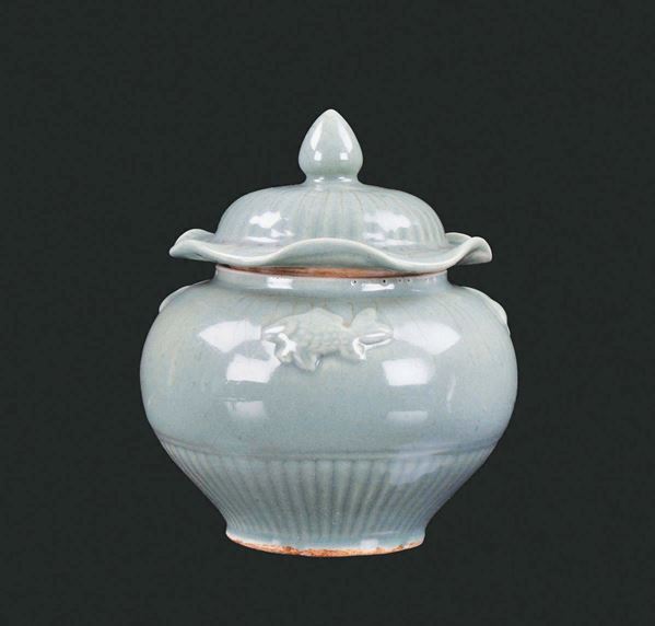 A small Celadon porcelain capped potiche, China, Yuan Dynasty (1279-1368)Decorated with carps in relief