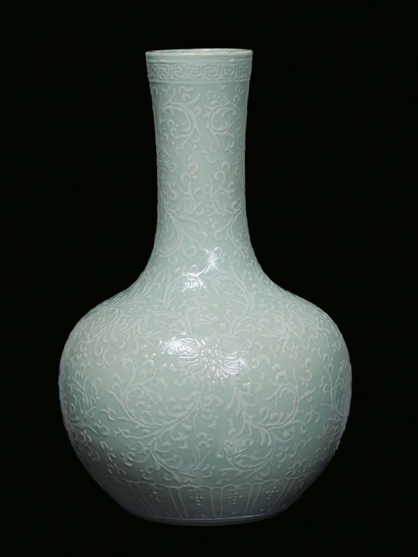A Celadon porcelain vase decorated in white in relief, China, Qing Dynasty, 19th century, apocryphal Qianlong mark