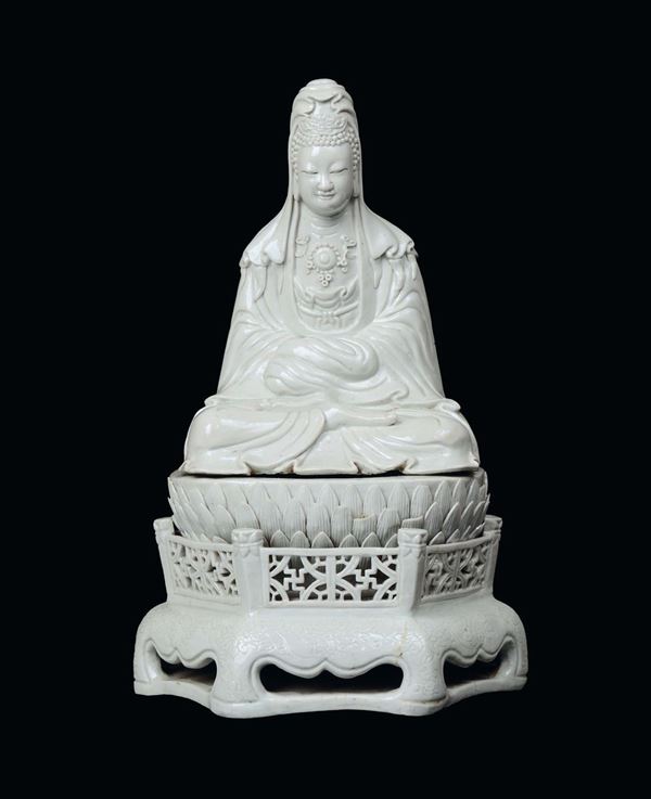 A rare white azure porcelain Guanyin sitting on a lotus flower with railing carved with swastikas and engraved design on the bases, China, Ming Dynasty, 17th century