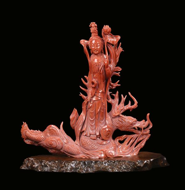 A carved red coral Guanyin with dragon, China, Qing Dynasty, late 19th century