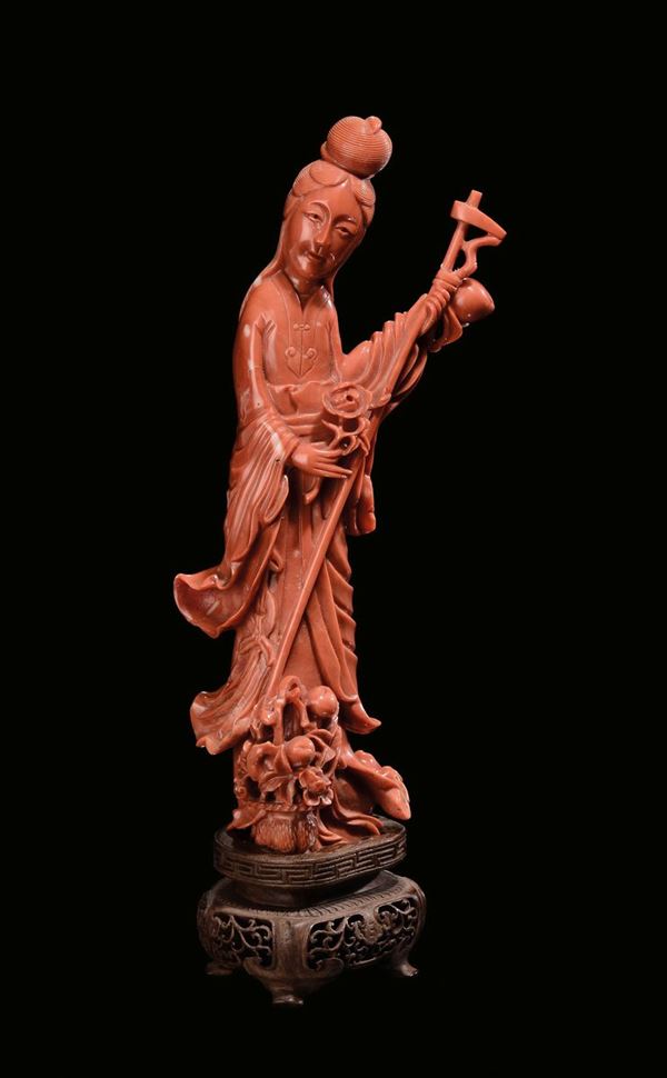 A carved red coral “Guanyin” group, China, Qing Dynasty, late 19th century