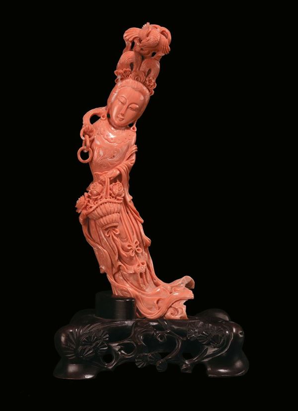 A coral figure of Guanyin with basket of flowers, China, early 20th century