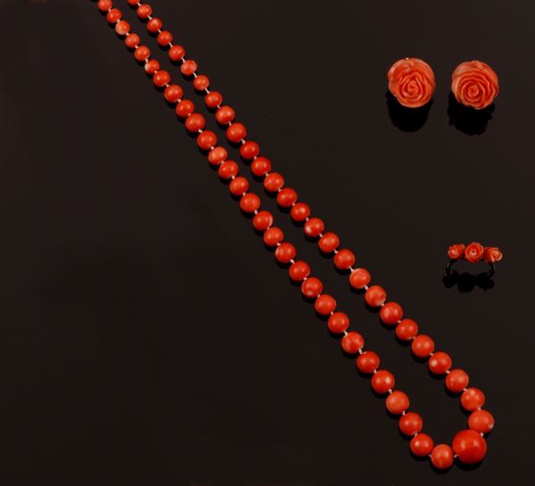 A carved coral parure comprising necklace, ring and a pair of earrings