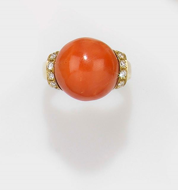 A coral, diamond and gold ring