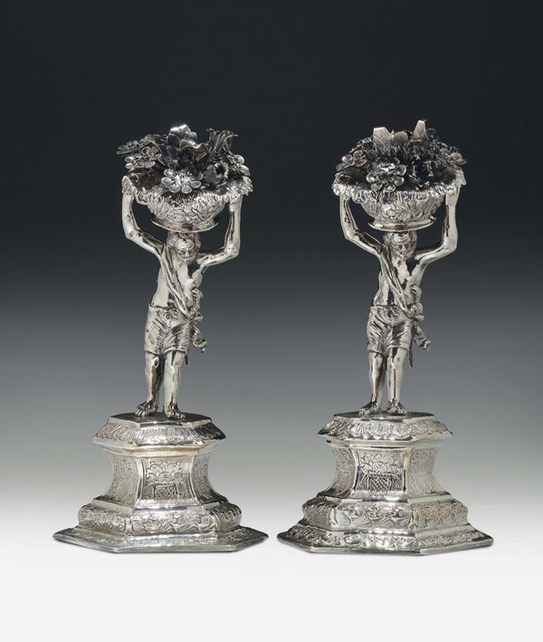 Figure virili con cesti di fiori Argento sbalzato, cesellato e inciso con parti fuse. Marchi: stemma  [..]