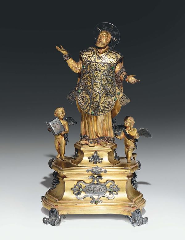 Gruppo di figure in bronzo fuso, cesellato, dorato e argentato, con pietre dure, raffigurante S. Filippo Neri con due angeli. Roma inizio  XVIII secolo