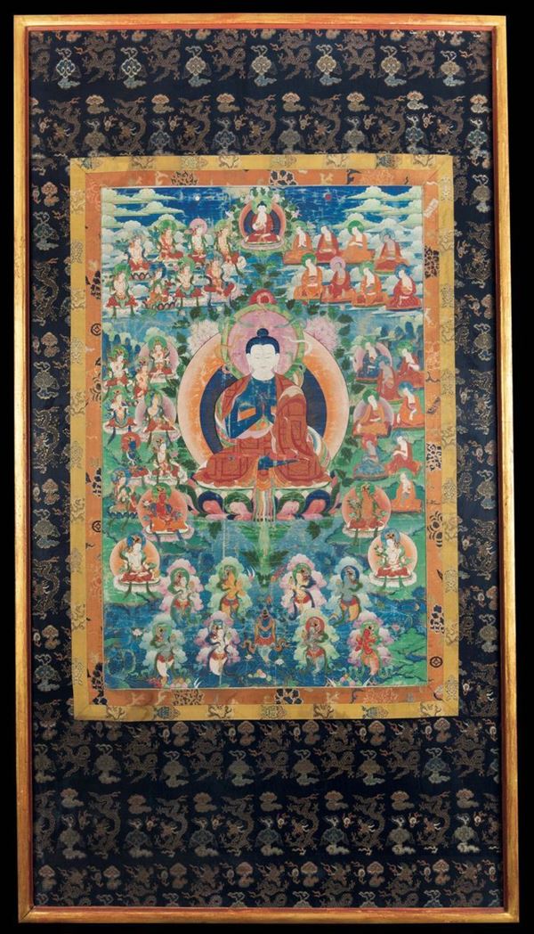 A framed tanka with a central figure of Buddha, Tibet, 19th century