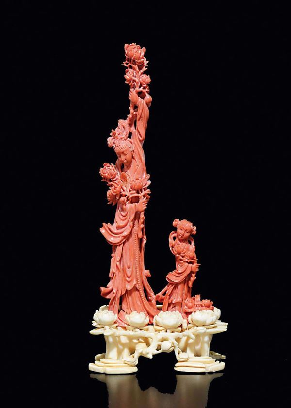 A carved coral figure of Guanyin with child on carved ivory stand, China, Qing Dynasty, late 19th century