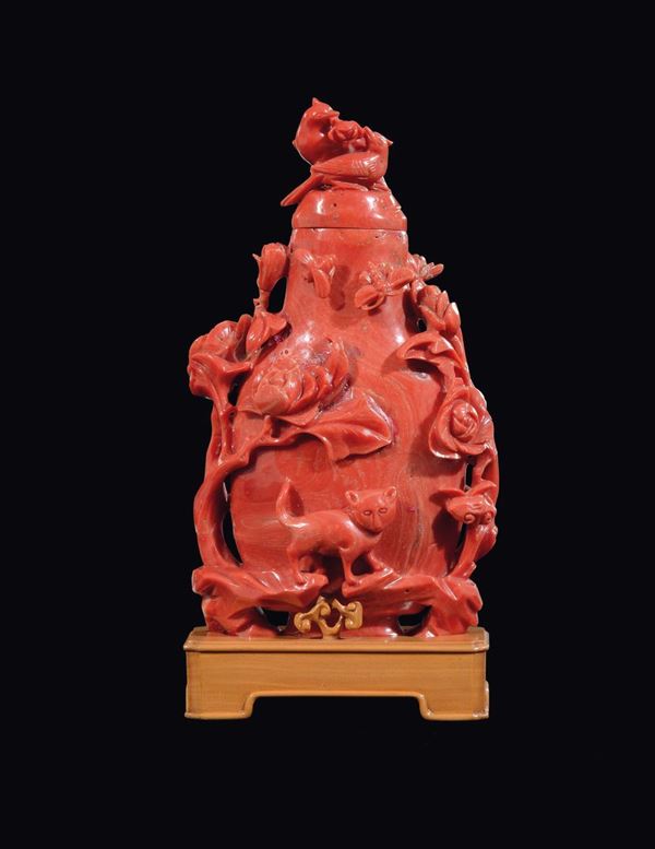 A carved coral vase and cover with birds and decoration of flowering branches, batterflies and a cat in relief, China, Qing Dynasty, 19th century