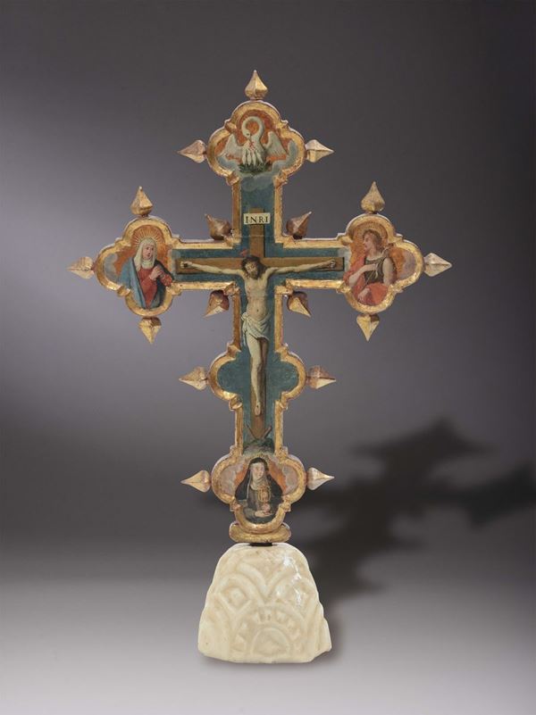 A painted wooden polylobed astile cross with Crucifixion and Saints, late 16th century school from central Italy