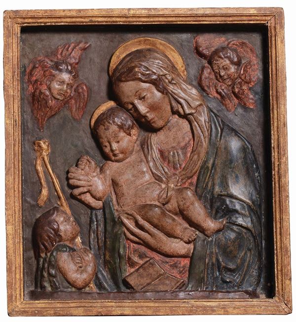A stucco polychrome relief with the Madonna and Child, Saint Giovannino and two cherubs. Benedetto da Maiano workshop (1442-1497), Florence, last quarter of the 15th century