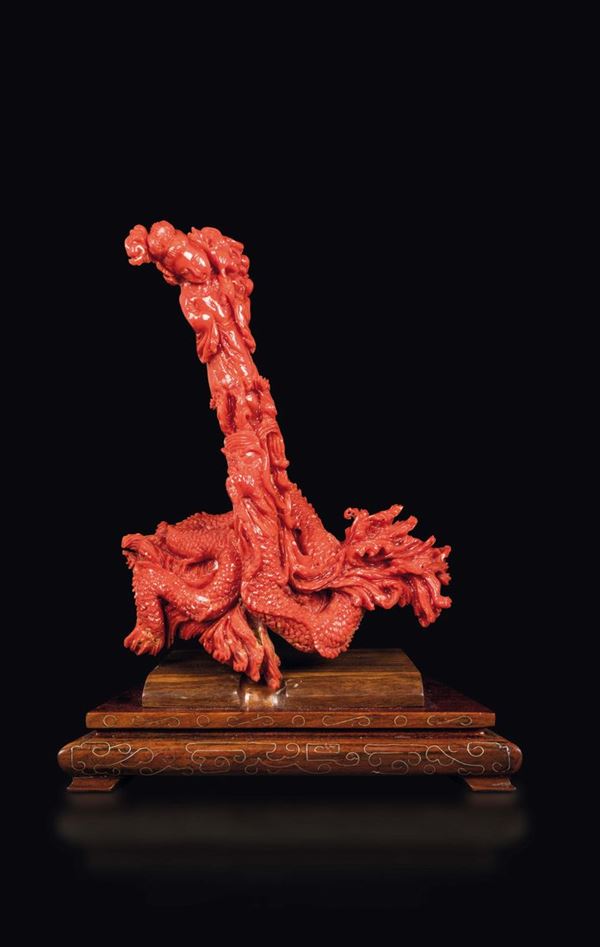 A carved coral Guanyin on a dragon group, China, early 20th century