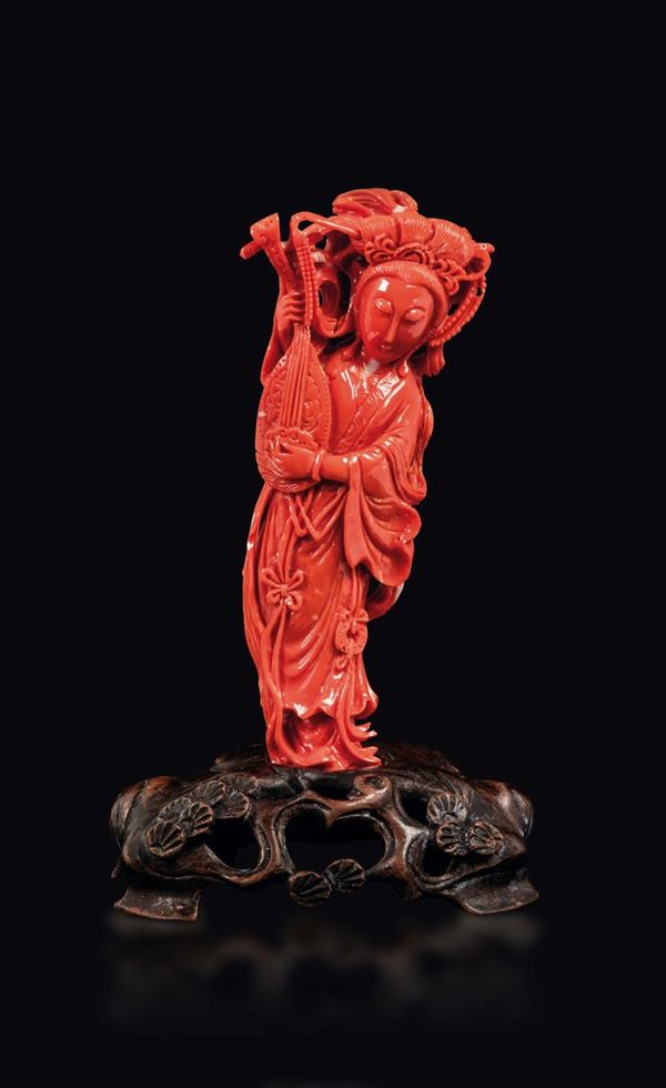A carved coral figure of Guanyin with musical instrument, China, early 20th century