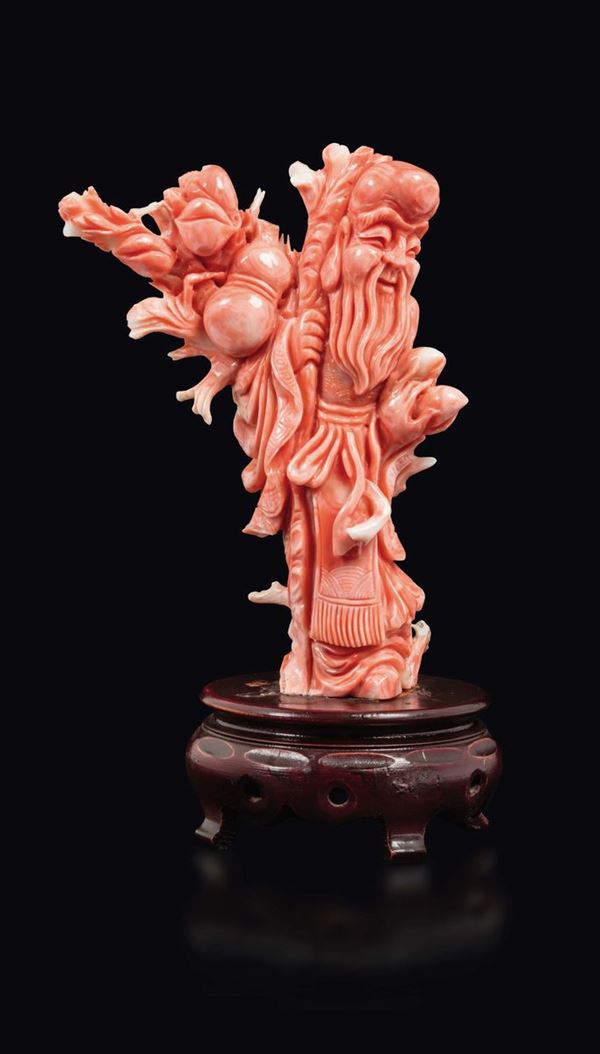 A carved coral figure of wise man with peaches, china, early 20th century