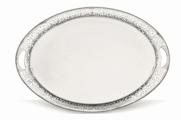 An oval platter in molten, embossed and perforated silver, city of Sheffield 1920, silversmith H. S. (unidentified)