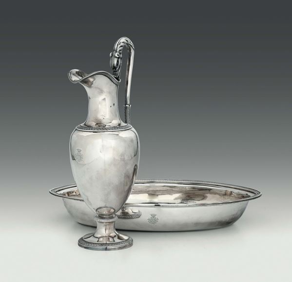 A pitcher and a basin in embossed and chiselled silver, Turin, 1815, mark of silversmith Carlo Balbino (1798 - 1824) and city's warranty stamp.