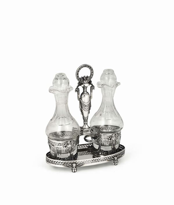 Oliera in argento fuso, sbalzato, traforato e cesellato. Bottiglie in vetro molato (non coeve), Parigi, bollo in uso dal 1838