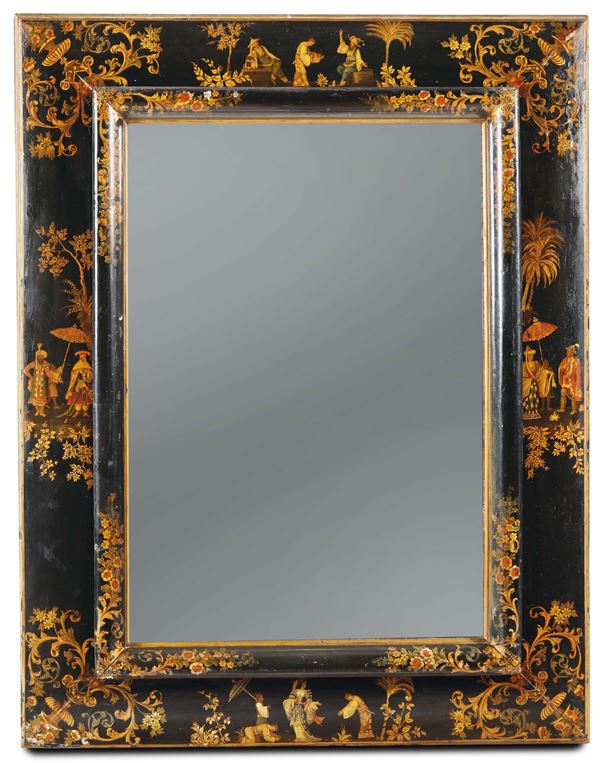 A wooden mirror, lacquered with a black background and decorated with polychrome figures, in Chinese style and fantastic, Venice, half of the 18th century