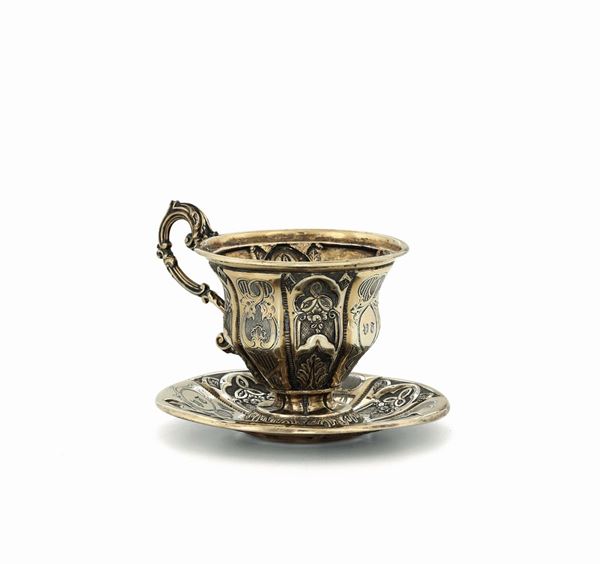 A cup and plate in first title vermeil silver, embossed and chiselled, France, title stamps in use after 1838 and silversmith's stamp.