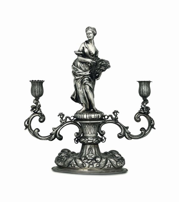 A two-arm candle holder in molten, embossed and chiselled silver. Austro-Hungarian empire (?), end of the 20th century