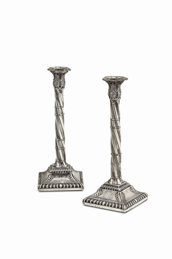 A pair of candle holders in sterling silver, molten, embossed and chiselled. London 1772, silversmith John Ashpinshaw