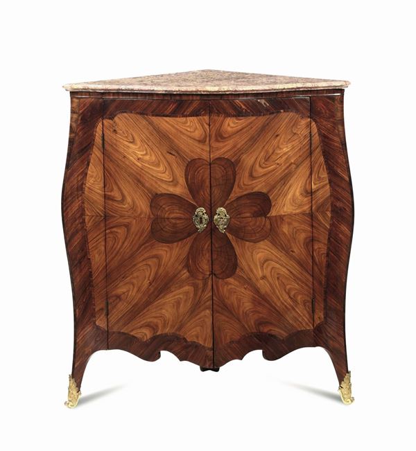A two-doored corner piece, veneered and carved in violet wood with a four-leaf clover decor, Genoa,  [..]