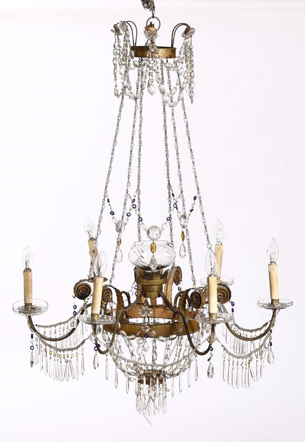 A pair of six-armed chandeliers in gilded bronze and crystals, first half of the 19th century