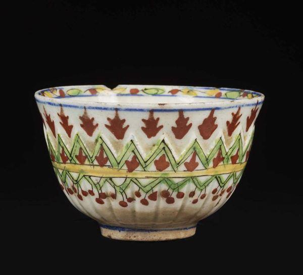 A small porcelain bowl with an embossed and polychrome stylised vegetal decor, Turkey, 18th century