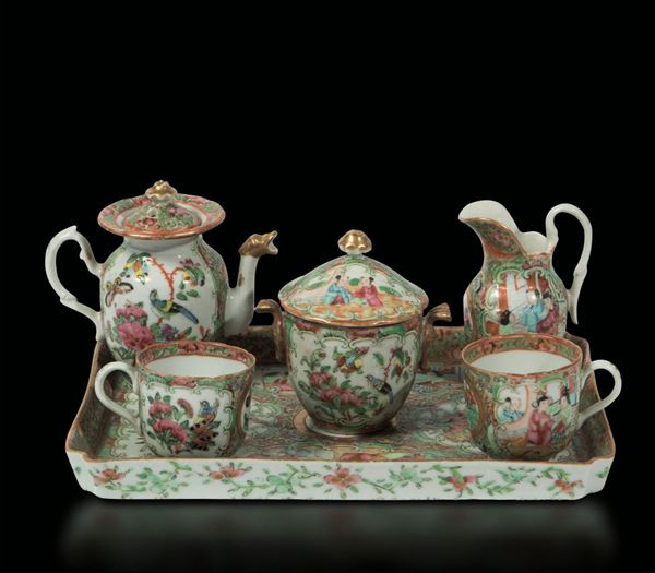A Canton porcelain tea service made up by a tray, a teapot, a milk jug, a sugar pot and two cups with everyday life scenes, China, Qing Dynasty, 19th century
