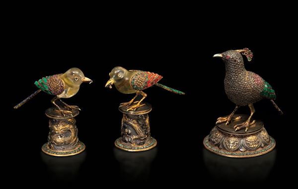 Lotto composto da tre figure in cristallo di rocca scolpito a foggia di uccellini con montatura in argento e inserti in pietre dure e smalti, Cina, XIX secolo