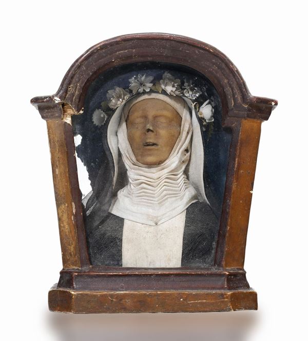 A wax abbess within a wooden case